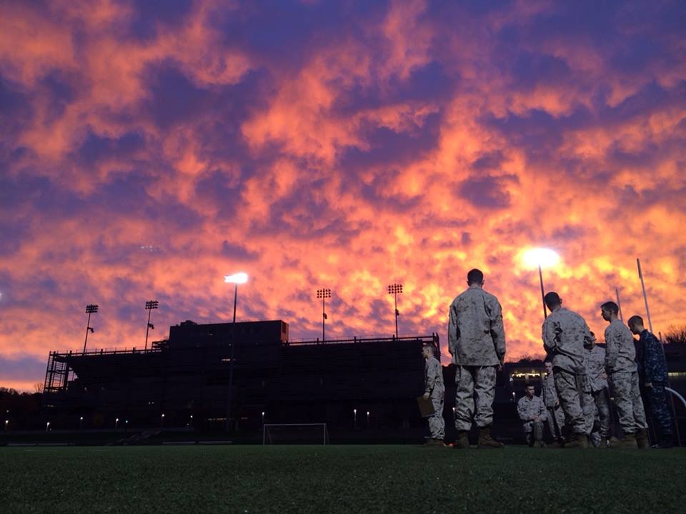 Multiple Naval Officers standing outside during sunset