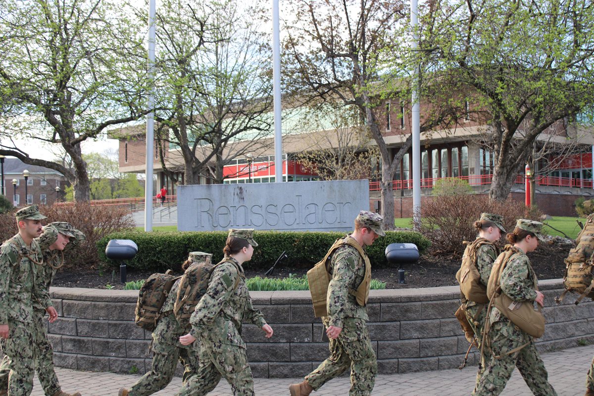 people in military uniform walking on campus